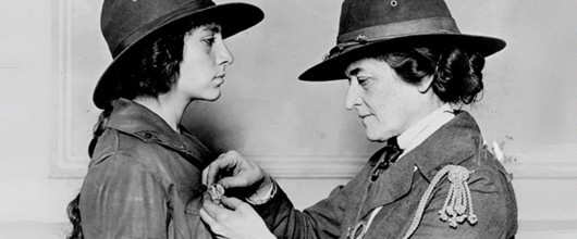 Old photo of girl scout receiving a badge